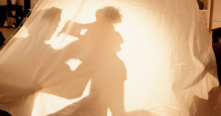 Family, shadow and playing game in tent for bonding, flying activity or fantasy airplane in home....