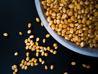 corn kernels spill from a bowl