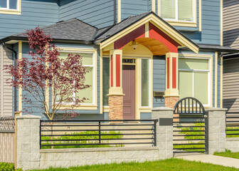Entrance of grey painted luxury house in summer with stair steps and nice landscape in Vancouver, Canada, North America. Day time on June 2024