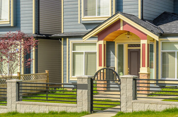 Entrance of grey painted luxury house in summer with stair steps and nice landscape in Vancouver, Canada, North America. Day time on June 2024