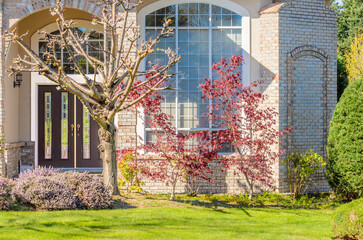 Entrance of grey painted luxury house in summer with stair steps and nice landscape in Vancouver, Canada, North America. Day time on June 2024