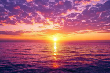 Obraz premium Purple and yellow sunset over the ocean with a boat in the distance