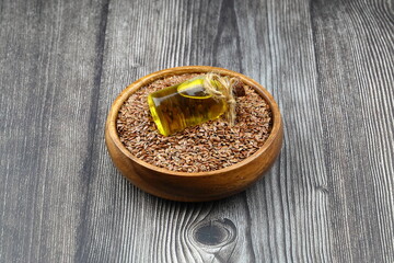 Flax seeds. Flaxseed powder in a wooden spoon. Standing on a Wooden background.