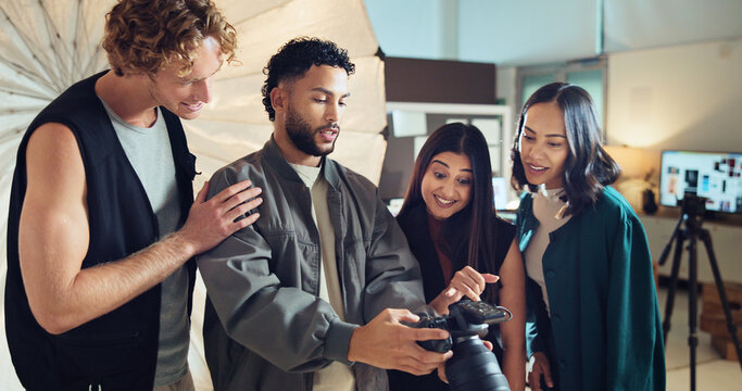 People, photographer and review camera in studio for photoshoot, photo results and production teamwork. Staff, check and tech for fashion photography, catalog and filming process of magazine industry