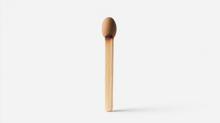 Macro closeup of a single wooden matchstick with striking head on textured surface, ready to ignite