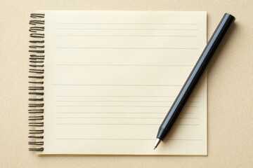 A notebook and a pen are placed on a surface together