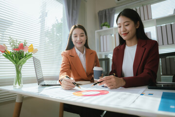 Businesswoman working with colleagues to define creative solutions strategies for organizational growth and leadership in the digital age.