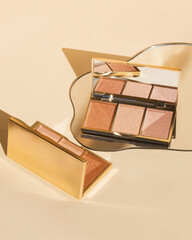 Gold highlighter makeup palette on gold background