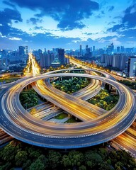 A stunning aerial view of a city highway at dusk, showcasing intricate road designs and vibrant city lights.