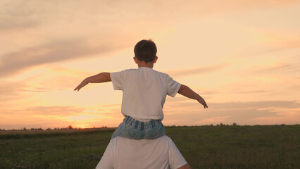 dad rides child kid boy son shoulders, father son runs sunset, children desire have wing, playing...