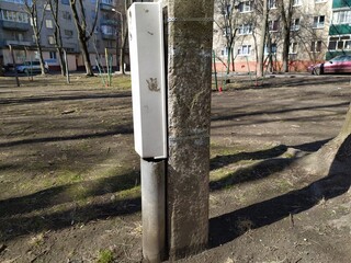 Old concrete pole on the street in spring