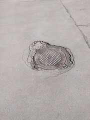 Manhole cover on the road. Repairing of the road.