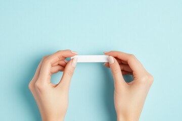 Hands Holding Blank Paper on Blue Background