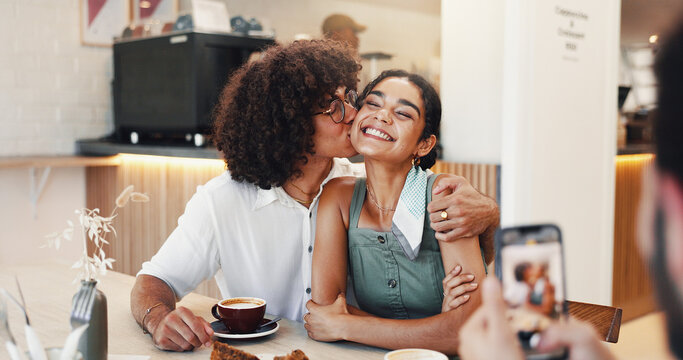 Couple, happy and kiss in picture in restaurant for coffee date memory, relationship support and social media post. Gen z people, smile and photography in cafe for bonding, romance and connection - Powered by Adobe