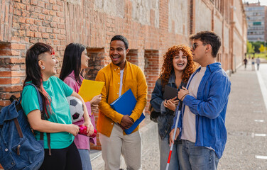 Diverse university students talking and laughing together on campus