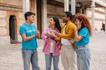 Volunteers discussing strategy for charity event outdoors