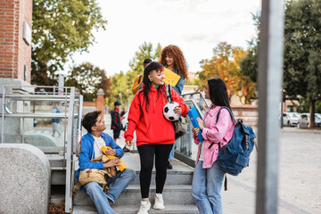 Fototapeta premium Diverse students talking on university steps after class