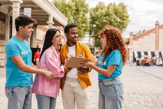 Volunteers collecting signatures outdoors for petition or survey