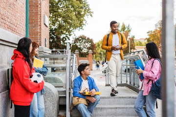 Fototapeta premium Multi ethnic students chatting on university steps