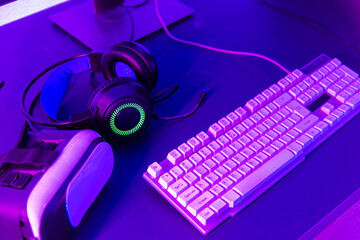 Close up gamer work space gaming set up modern equipment on desk, gaming gear, mouse, headset, computer mouse ready for online streaming © sorapop