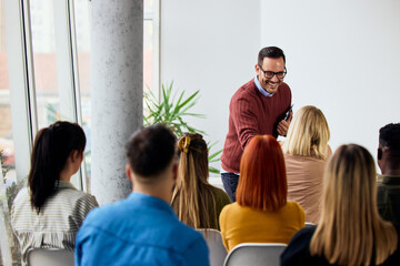 Friendly Teacher Engaging With Adult Students in a Bright Classroom