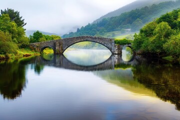 Fototapeta premium Stunning Arched Stone Bridge In Lush Greenery