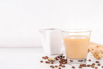Fresh brewed ginger coffee latte cup. Creamy hot drink with ginger powder and ginger root, on white background. Healthy hot beverage. alternative medicine, remedy 