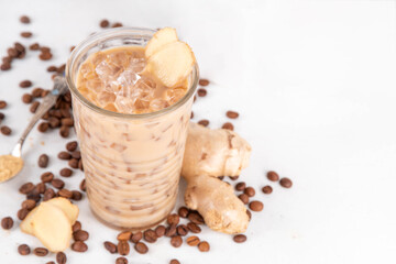 Cold brewed ginger coffee latte cup. Creamy iced drink with ginger powder and ginger root, on white background. Healthy hot beverage. alternative medicine, remedy 