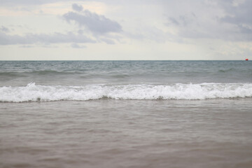 Sea view with small waves in cloudy weather. Balearic Sea, Salou, Spain. View of the waves on the sea from a lower angle. Landscape with sea and clouds