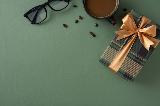 Elegant presentation featuring a gift box with ribbon, eyeglasses, coffee cup, and beans. Ideal for special occasions like Father's Day or gifts theme
