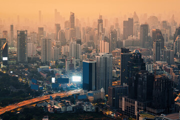 Fototapeta premium Crowded financial skyscraper building with rush traffic in the morning at Bangkok city