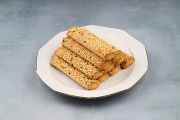 A plate of cookies is sitting on the table.