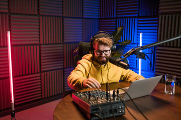Handsome man radio DJ hosting a radio show, entertainment and communication concept
