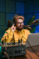 Handsome man radio DJ hosting a radio show, entertainment and communication concept