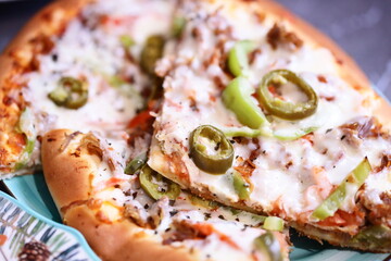 A close-up shot of a slice of pizza on a plate, perfect for food and culinary-themed projects.