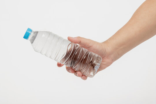 Hand holding water bottle isolated on white background with clipping path