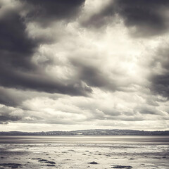 Obraz premium Dramatic sky over calm sea, distant land. Perfect for travel, nature, and weather-related projects