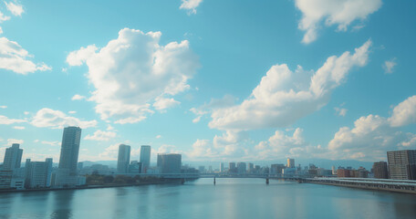 Fototapeta premium Daytime cityscape of Osaka with blue skies and calm river.