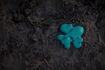 Airplane toy on black beach sand