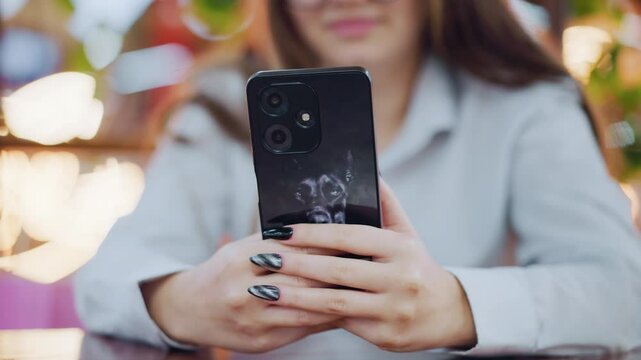Close-up of iPhone with donkey sticker as owner operates it, with soft blur background, a stylish and personal phone case adds a unique touch to daily smartphone use