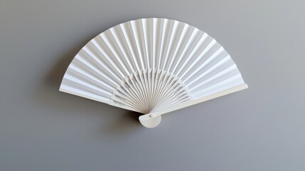 White hand fan isolated on gray background. Open folding fan for mock-up