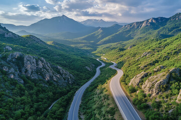 Fototapeta premium Landscape view of uphill road among forest with peaceful and relax vibe in the morning, Aerial view natural trail on the hill among the valley.