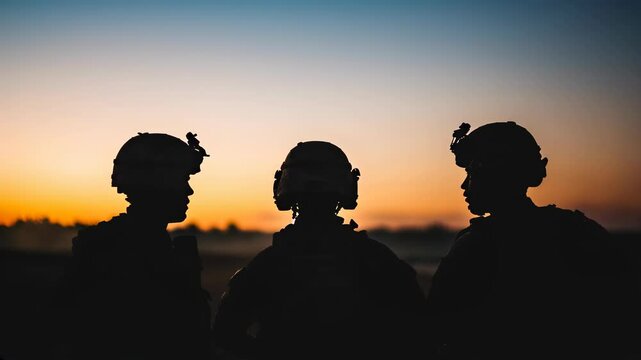 Three soldiers in silhouette at sunset, concept for military talking to each other
