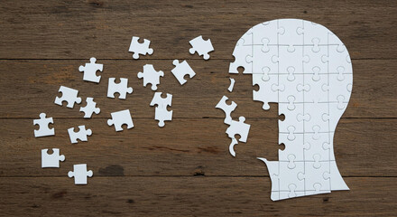 Incomplete Jigsaw Puzzle Head on Wooden Background Representing Mental Health Missing Pieces