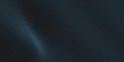 Abstract dark grainy background with a subtle blue light gradient across the surface area © Abdur rahim