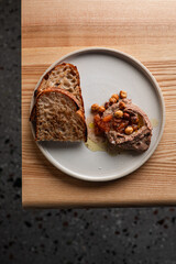 Minimalist Gourmet Pâté with Sourdough and Hazelnuts on a Modern Plate

