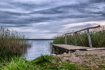 Wooden bridges on the shore of Lake Pesno, among reed thickets, in the park of the Rimsky-Korsakov estate in the Pskov Region.
