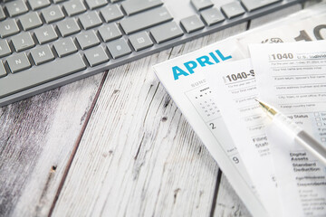 Filling out a tax form. Computer, form and pen on your desk. state taxes and calculating your tax return.