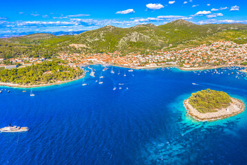 Aerial view of Hvar Town, Croatia, showcasing its vibrant waterfront, and the sparkling Adriatic...