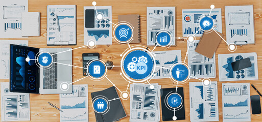 Explore a modern office environment where various business documents and technology converge to assess performance metrics and data analysis for strategic planning. Amity